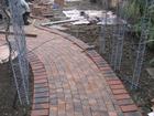 The brick path goes in..